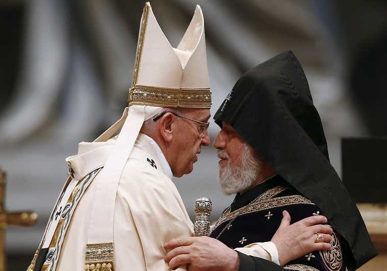 Pope Francis (L) embraces Catholicos of All Armenians Karekin II during a mass on the 100th anniversary of the Armenian mass killings, in St. Peter's Basilica at the Vatican 