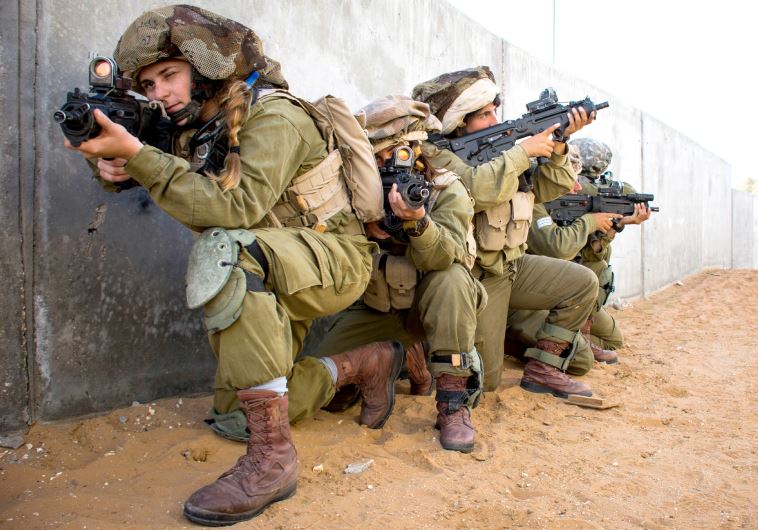 Female combat soldiers in the mixed-gender Caracal Battalion train in urban warfare.