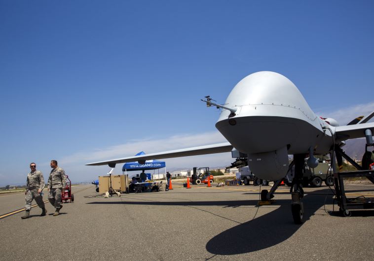 A General Atomics MQ-9 Reaper stands on the runway during "Black Dart", a live-fly, live fire demonstration of 55 unmanned aerial vehicles