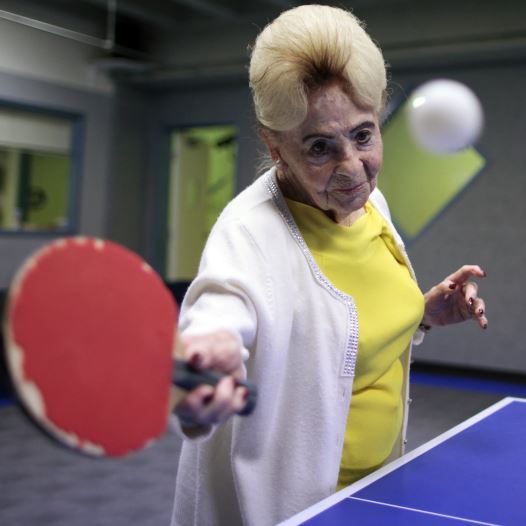 Holocaust survivor Betty Stein, 92, (L) and Eli Boyer, 91, play ping pong at a program for people with Alzheimer's and dementia at the Arthur Gilbert table tennis center in Los Angeles