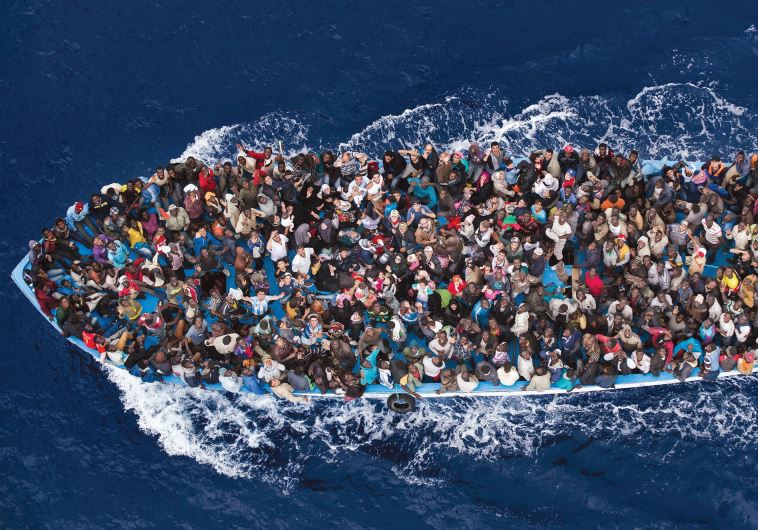 Massimo Sestini’s entry, which took second place in the General News slot, is a colorful overhead shot of refugees packed into a boat off the Libyan coast, prior to being rescued by an Italian naval frigate.