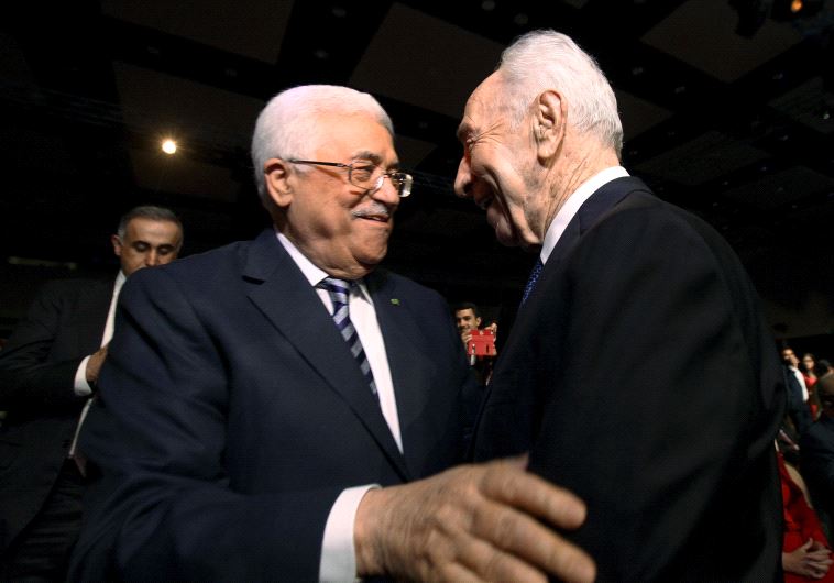 Former Israeli president Shimon Peres (R) shakes hands with Palestinian Authority President Mahmoud Abbas (C) at the World Economic Forum on the Middle East and North Africa at the King Hussein Convention Centre at the Dead Sea May 22, 2015