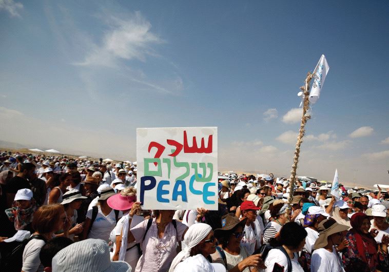 Activists, including Israelis and Palestinians, take part in a demonstration in support of peace near Jericho