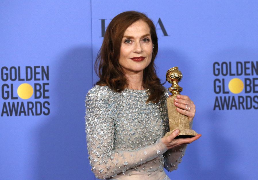 Actress Isabelle Huppert poses backstage with her award for Best Performance by an Actress in a Motion Picture - Drama for her role in "Elle," at the 74th Annual Golden Globe Awards.
