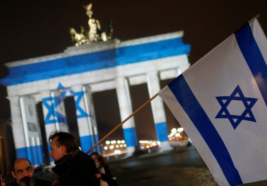 The Brandenburg Gate in Berlin, Germany, is illuminated with the colours of the Israeli flag to show solidarity with Israel