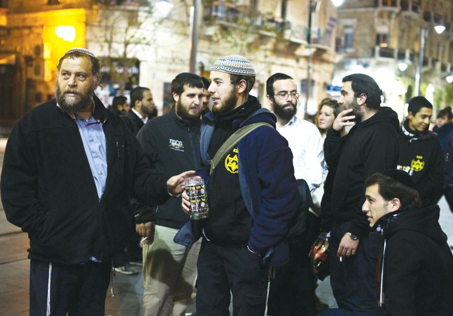 Ben-Zion Gopstein (left), leader of the group Lehava, gathers with some of his young followers in Jerusalem in 2014