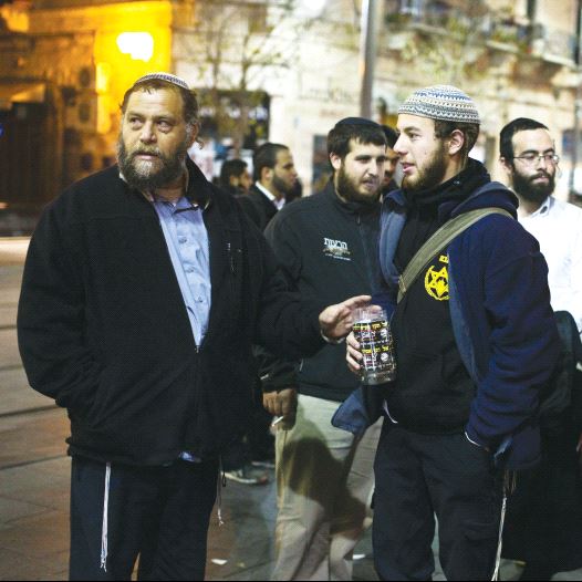 Ben-Zion Gopstein (left), leader of the group Lehava, gathers with some of his young followers in Jerusalem in 2014