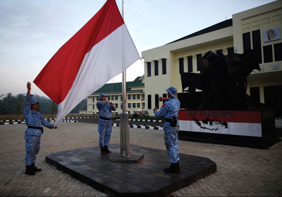 PARTICIPANTS RAISE an Indonesian flag at a training center in Rumpin, Indonesia, last June.