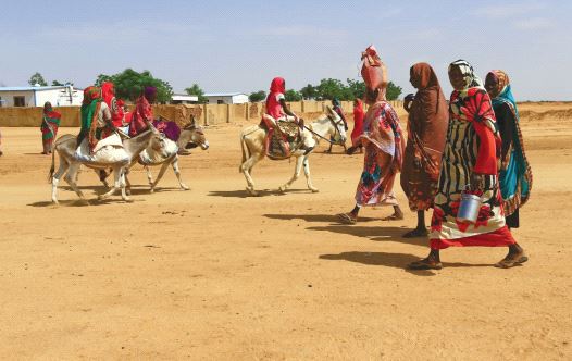 WOMEN WALK to the market in Abu Shock IDPs camp in Al Fashir, capital of North Darfur, Sudan, last year.