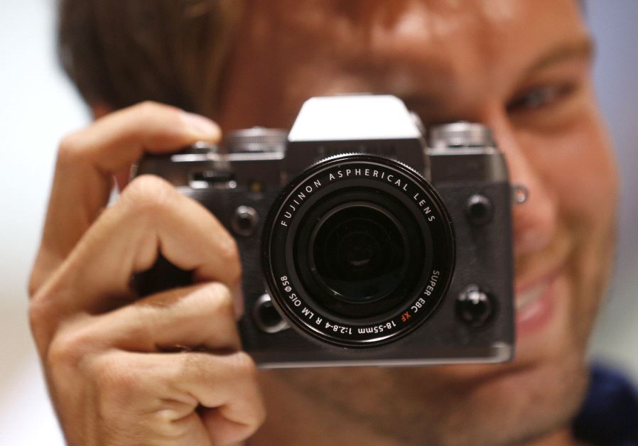A model poses with a camera