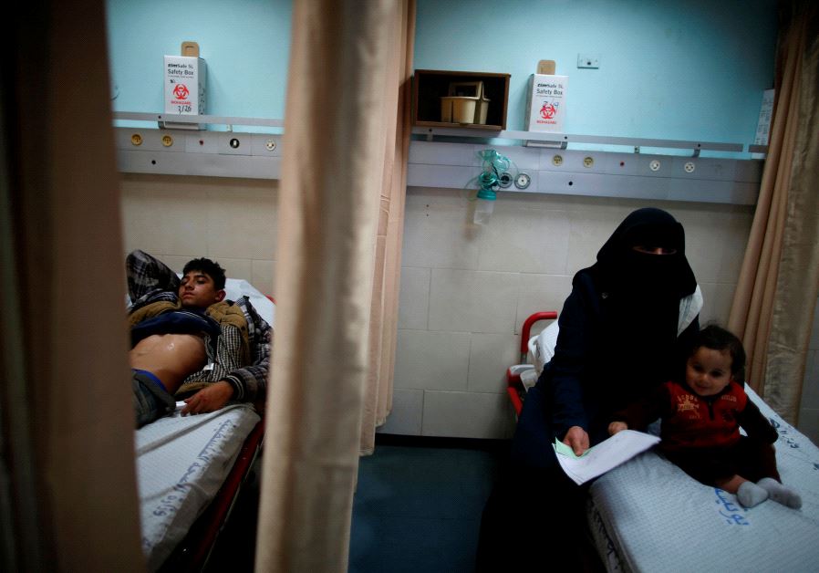 Palestinian boy Ahmed Abu Saman, 16, who was injured in a car accident, lies on a bed at the emergency department at Shifa hospital, Gaza's largest public medical facility, in Gaza City, March 29, 2017.
