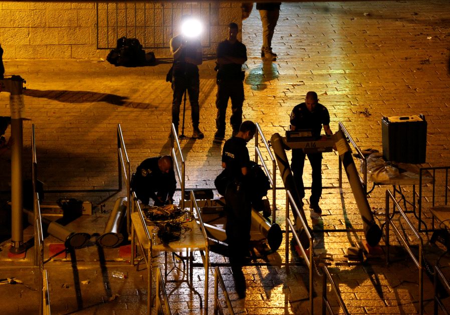 Israeli security forces remove metal detectors which were recently installed at an entrance to the Temple Mount